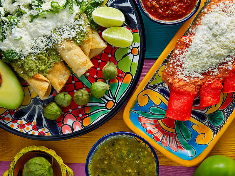 A selection of Mexican dishes on colorful plates
