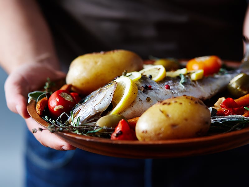 a plated dish of fish and vegetables